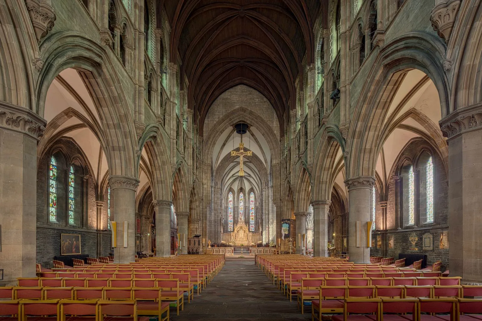 Church sanctuary interior with high ceilings and rows of pews